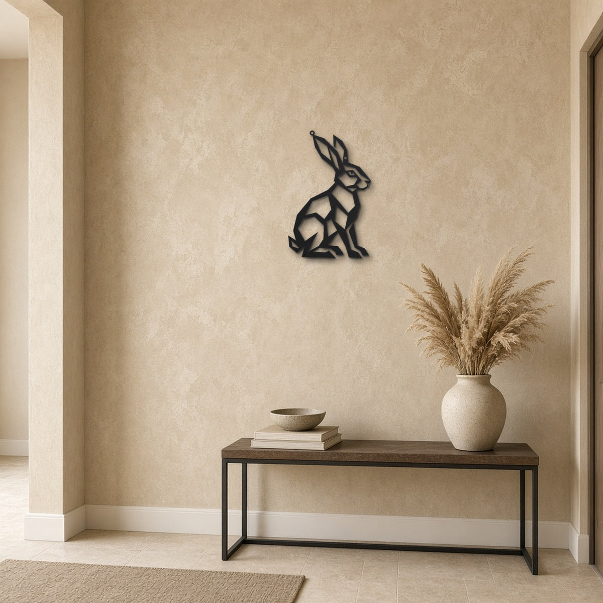 Geometric Hare black metal wall art hanging on a hallway wall