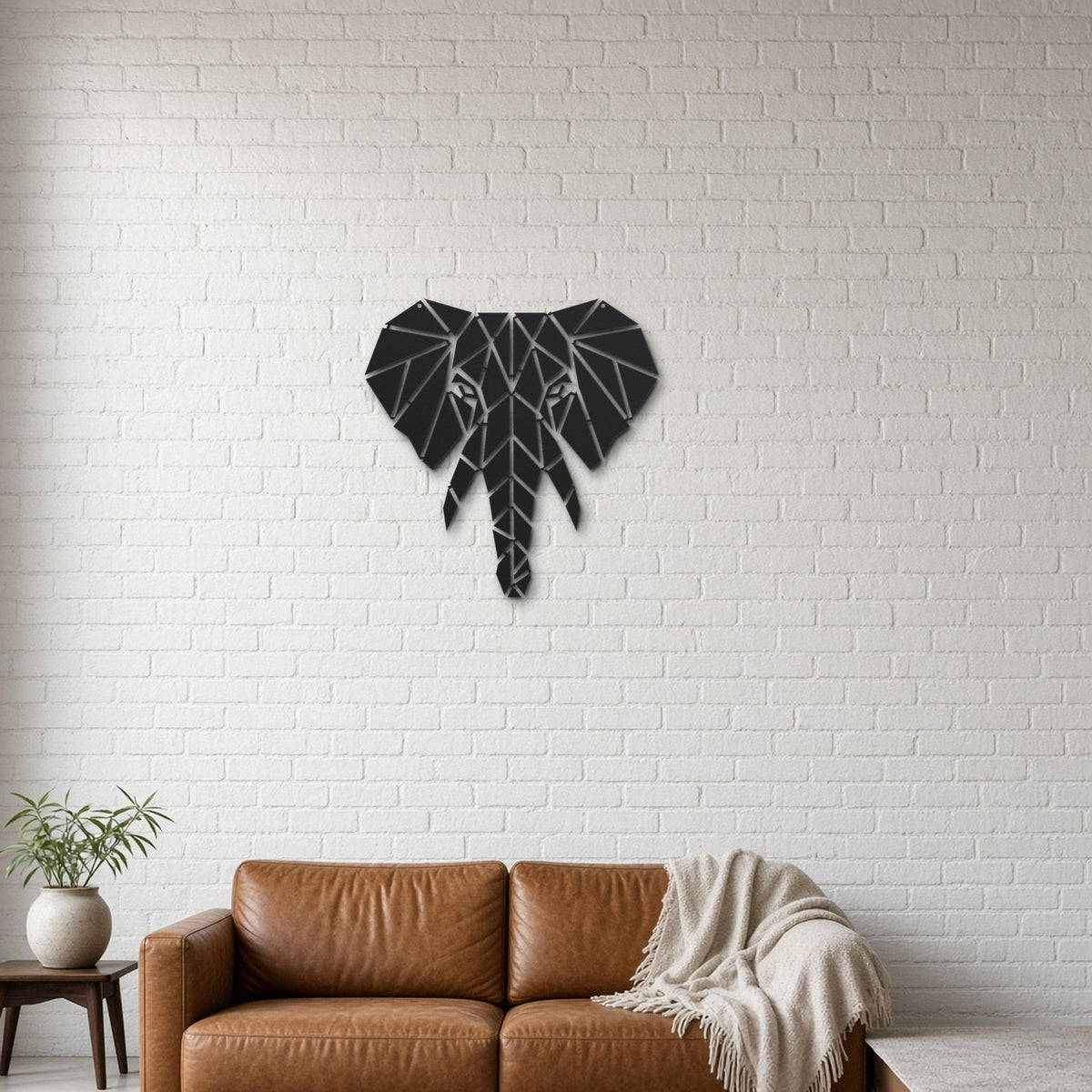 Geometric Elephant Head black metal wall art hanging on a lounge with white brick wall wall