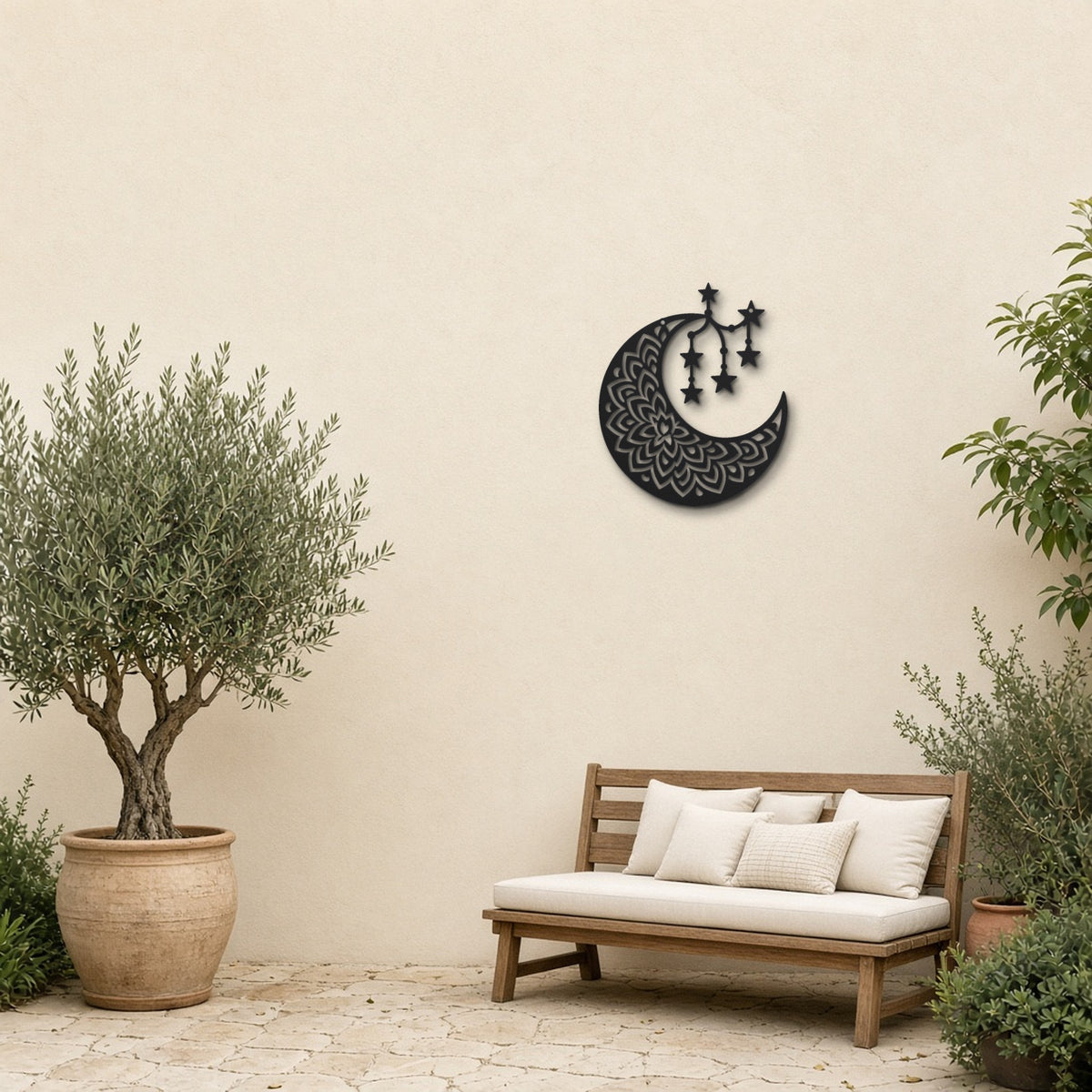 Boho Moon Mandala black metal wall art hanging on a garden patio wall