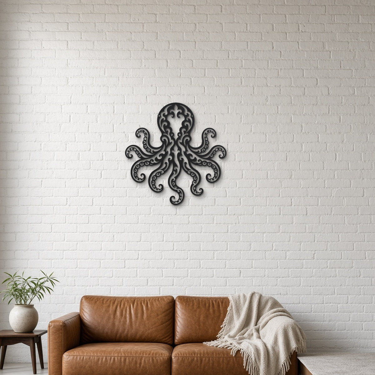 Octopus black metal wall art hanging on a lounge with white brick wall wall
