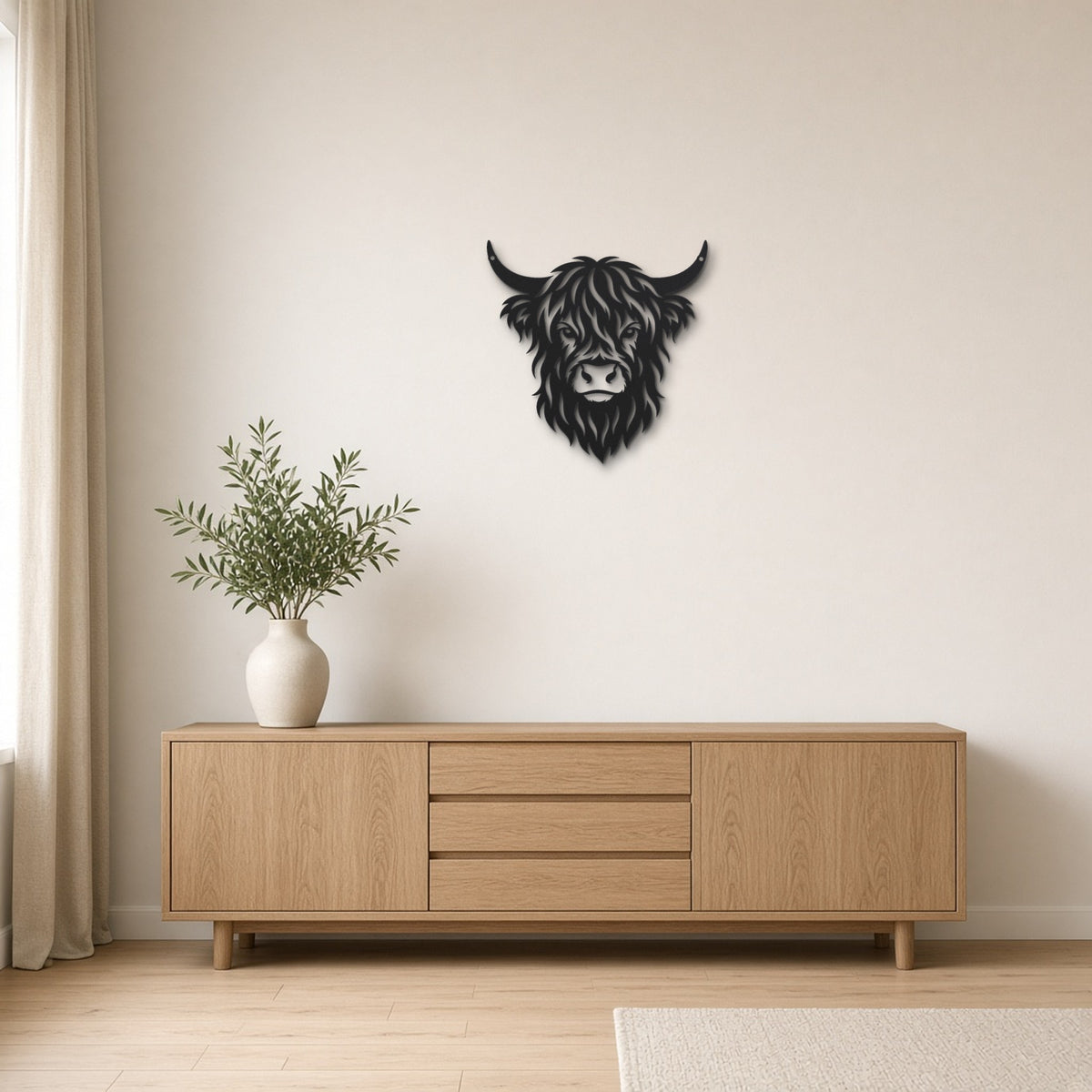 Highland Cow black metal wall art hanging on a Scandinavian living room wall