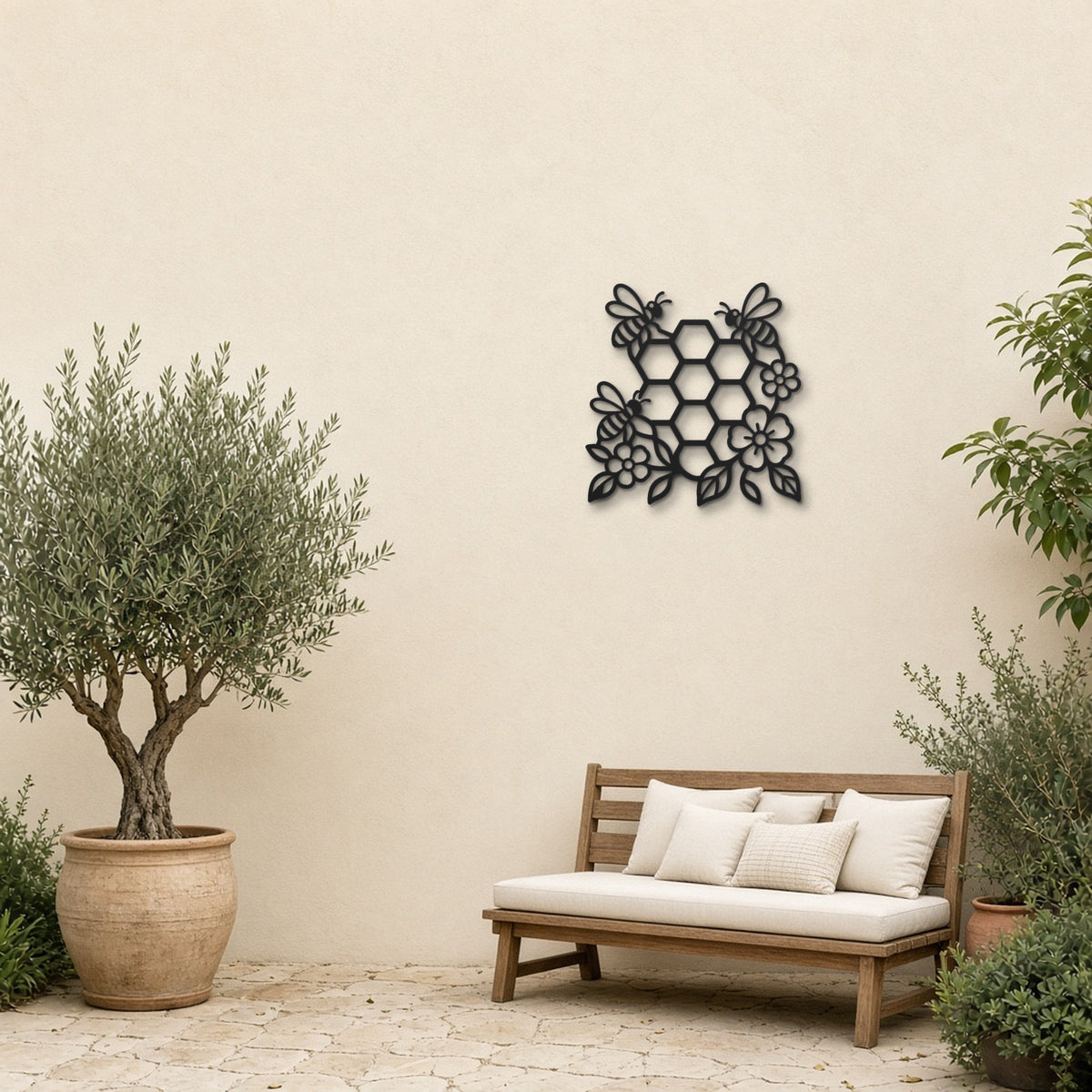 Bee and Honeycomb black metal wall art hanging on a garden patio wall