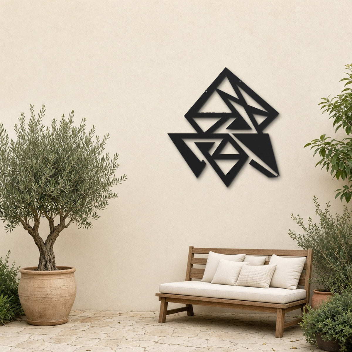 Geometric Triangles black metal wall art hanging on a garden patio wall