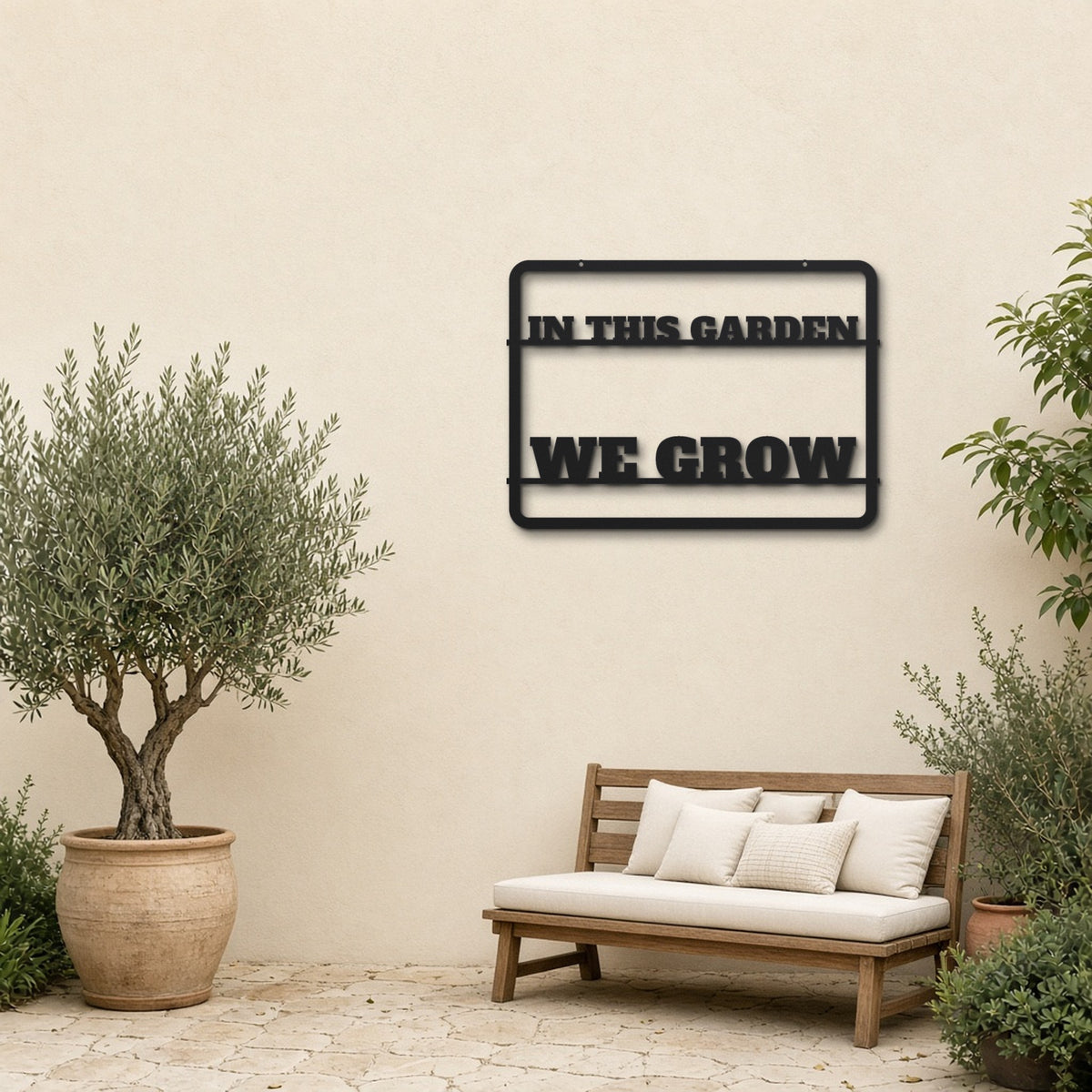 Garden Grows black metal wall art hanging on a garden patio wall