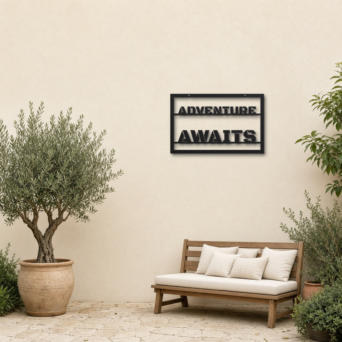 Adventure Awaits black metal wall art hanging on a garden patio wall