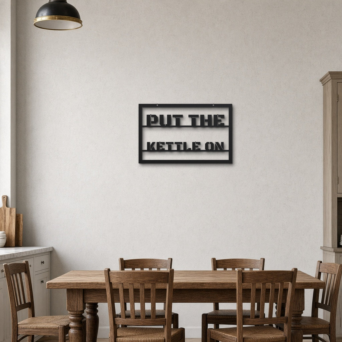 Put The Kettle On black metal wall art hanging on a farmhouse kitchen wall