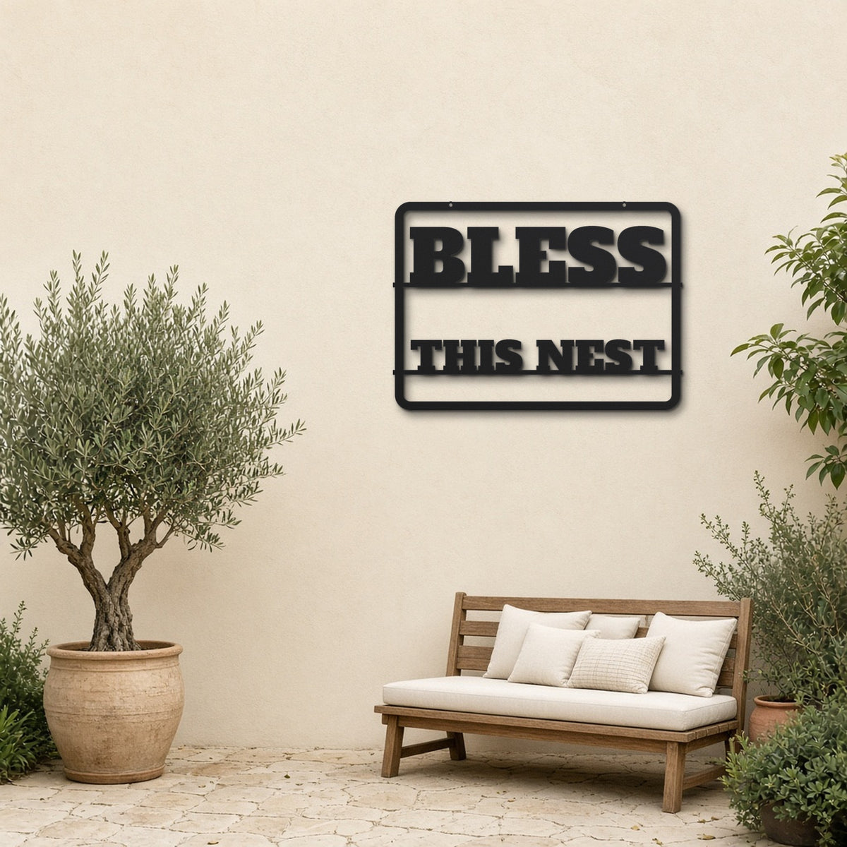 Bless This Nest black metal wall art hanging on a garden patio wall