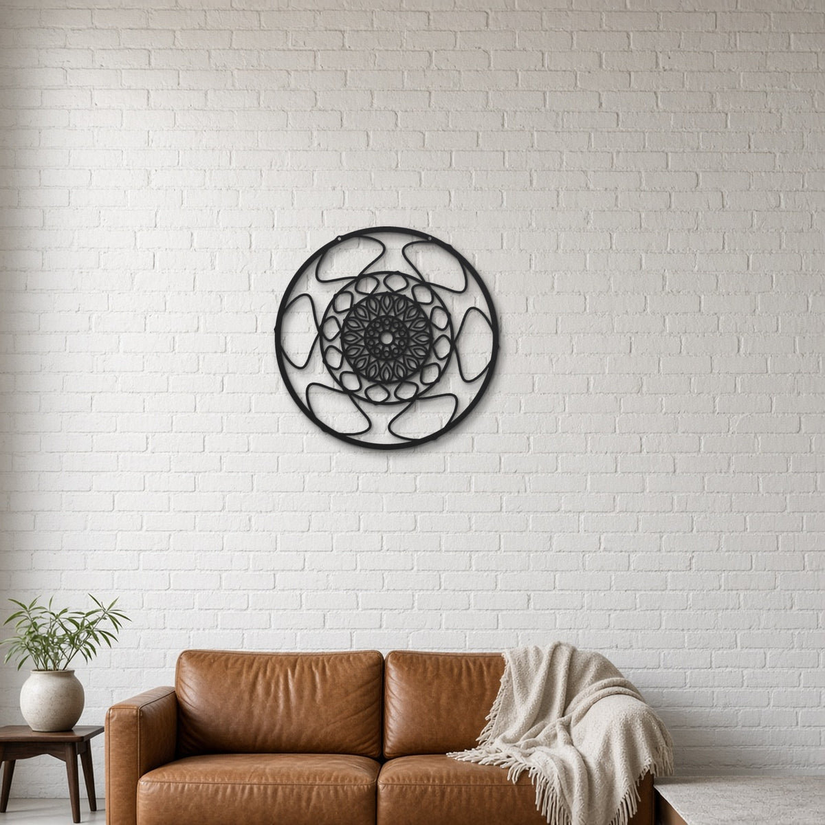 Geometric Mandala Snowflake black metal wall art hanging on a lounge with white brick wall wall