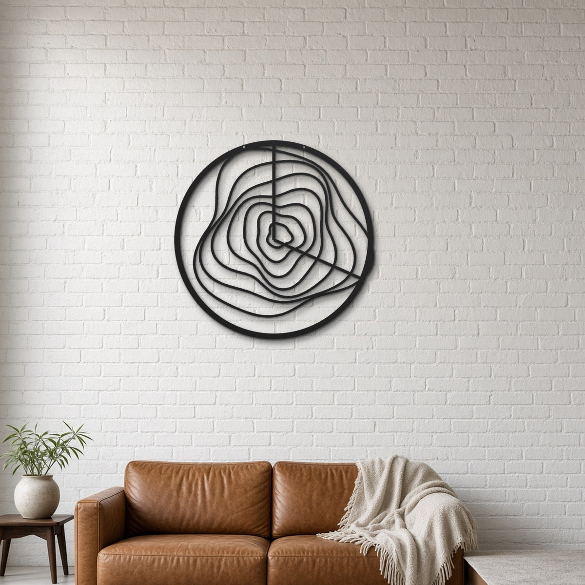 Contour Lines black metal wall art hanging on a lounge with white brick wall wall